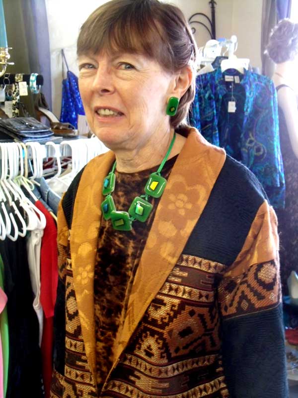 Ann sets off brown with a five-piece green fused glass necklace with varied dichroic glass in the center matching earrings