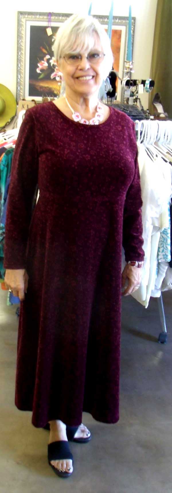 Joanne shows off a burgundy dress, highlighted by a five-piece fused glass necklace in pink, with magenta and red dichroic, and matching earrings
