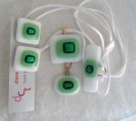 2-piece pendant, white with light green with green dichroic center on white cord, matching fob to hold it on, $30.00; matching pierced earrings, surgical steel posts, $16.00